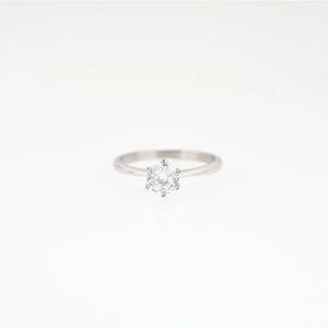 Minimalist titanium steel moissanite ring with six-prong setting on white background