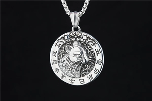 Macro detail of silver titanium steel necklace featuring Chinese zodiac rat relief pendant