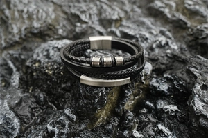 Detail of multi-layer black leather braid with silver stainless steel magnetic clasp