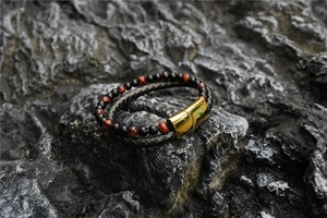 Detail of double-layer bracelet featuring tiger eye stones and a golden magnetic clasp