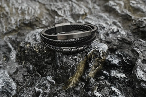 Macro shot of multi-layer woven leather bracelet with gun-black magnetic metal clasp