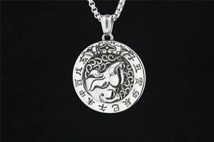 Detailed close-up of retro zodiac pendant with silver finish and Chinese character engravings