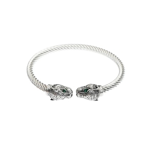 Silver twisted cable cuff bracelet featuring dual leopard heads with green stone eyes