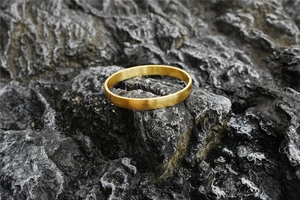 Detail of gold brushed titanium steel bracelet featuring a secure invisible clasp design
