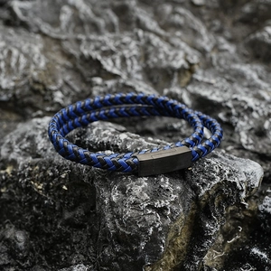 Men's double-wrap braided leather bracelet with matte black magnetic clasp on rock base