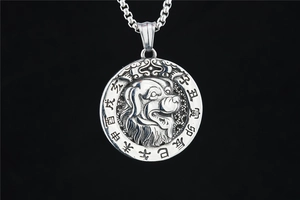Macro shot of silver retro dog pendant necklace with traditional zodiac engraving