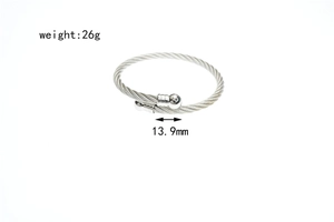 Detail view of woven stainless steel cable bracelet with polished beads and 13.9mm size