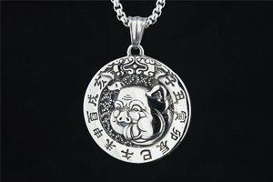 Macro detail of silver Chinese zodiac pig pendant with traditional twelve earthly branches