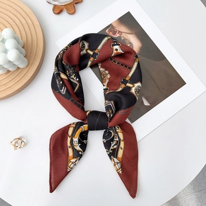 Detail of retro chain print silk scarf with caramel and black satin texture