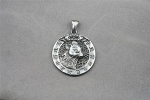 Macro detail of silver titanium steel necklace pendant featuring zodiac rat engraving