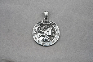 Macro detail of silver titanium steel round pendant with relief horse and Chinese zodiac
