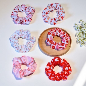 Pink heart and LOVE print elastic scrunchies set with floral decor on wooden tray