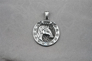 Macro shot of vintage titanium steel zodiac horse pendant with engraved Chinese characters