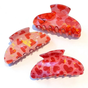 Three-piece romantic pink claw clip set with red heart prints on polished acrylic