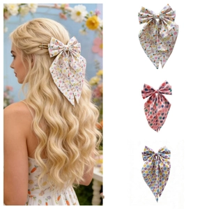 Close-up of Easter rabbit and egg patterns on large bow hair clips with long ribbons