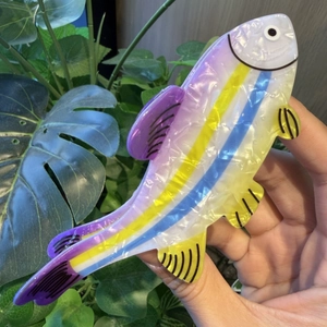 Colorful acetate fish hair claw clip with iridescent purple and blue stripes