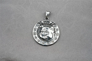 Macro shot of retro steel zodiac pig pendant with traditional Chinese characters