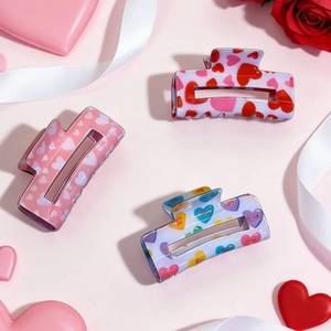 Detail of square hair claws with colorful heart patterns and romantic love prints