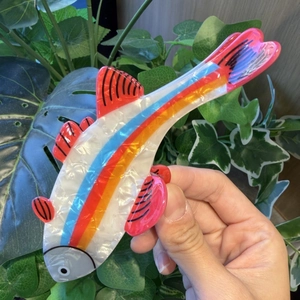 Cute trout fish hair claw clip with colorful stripes and vibrant red fins in action