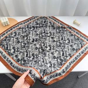 Detail of vintage horse carriage pattern on a large square scarf with retro brown border