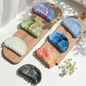 Detailed set of 7 marble texture hair claws in various vibrant summer colors