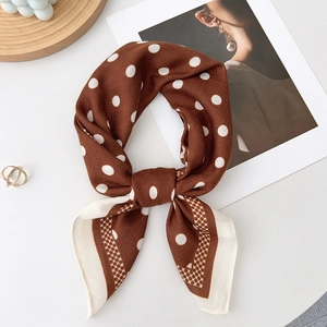 Brown polka dot silk scarf detail showing vintage pattern and elegant silk texture