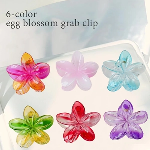 Set of six colorful frangipani flower hair clips in various bright resin shades