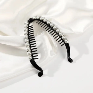 Elegant black banana hair clip with white pearls and rhinestones on white silk