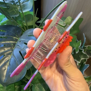 Detail of colorful trout fish hair claw clip with creative pink and orange gradient design