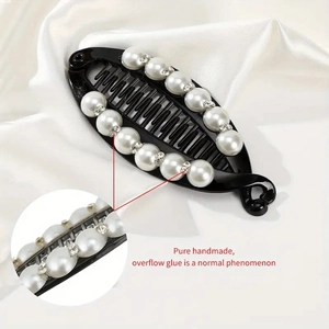 Detailed close-up showing pearls and rhinestones on the handmade banana hair clip