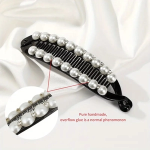 Detail of handmade black banana hair clip with white pearls and sparkling rhinestones
