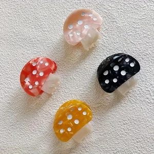 Polka dot mushroom acetate hair claws in pink, red, black, and yellow colors