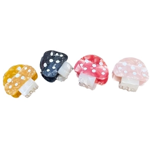 Polka dot mushroom acetate hair claws in yellow, black, red, and pink colors