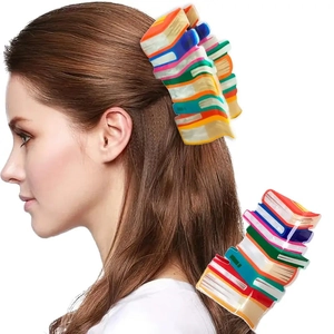 Detailed view of large colorful book-shaped hair claw clip for a stylish ponytail look