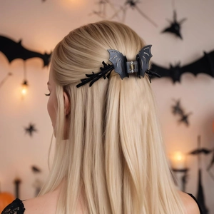 Halloween bat hair claw clip accessory worn on ponytail in festive background