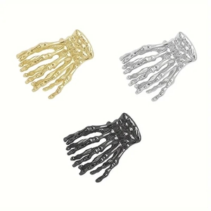 Drei Punk-Skeletthand-Haarklammern in Gold, Silber und Schwarz auf weißem Hintergrund