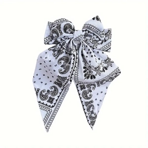 Vintage bohemian paisley print large bow hair clip with long streamers on white backdrop