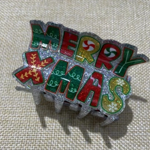 Glittery Merry Xmas letter hair claw clip for women in festive red and green colors