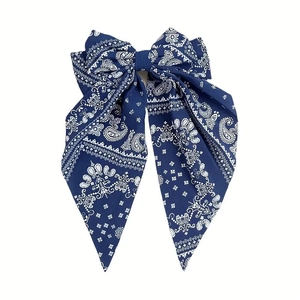 Close-up of dark blue paisley print bow hair clip with vintage bohemian flowing ribbons