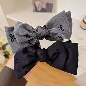 Elegant bow hair claw set with denim and twill texture featuring butterfly embroidery