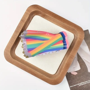 Rainbow striped colorful hair claw clip made of acetate on a minimalist white display tray
