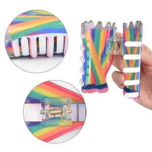 Rainbow striped hair claw clip with floral pattern and resin grip shown in three-view layout