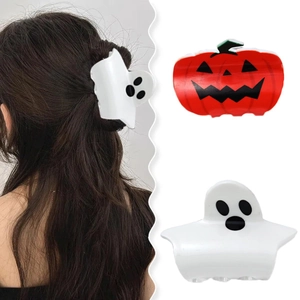 Close-up of white ghost and orange pumpkin hair claws for Halloween hairstyles