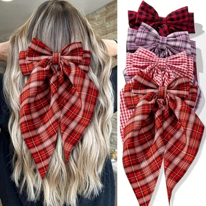 Red plaid large bow hair clip for ponytail styling shown on model and multiple colors
