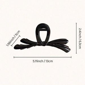 Pince à cheveux noeud noir brillant au design minimaliste pour coiffure femme
