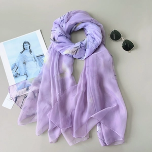 Lightweight lavender floral sheer scarf and summer shawl elegantly styled on a desk