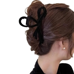 Elegant black velvet bow hair claw clip for bun styling with a matte flocked finish