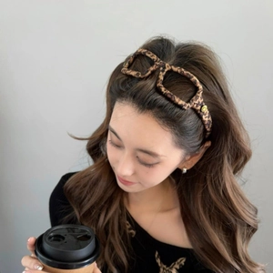 Elegant leopard print headband in glasses shape with golden smiley face detail