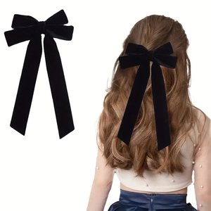 Long black velvet double bow hair clip with streamers shown on model and white background