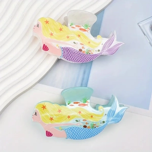 Detail of cartoon mermaid hair claws in purple and blue with sea theme patterns